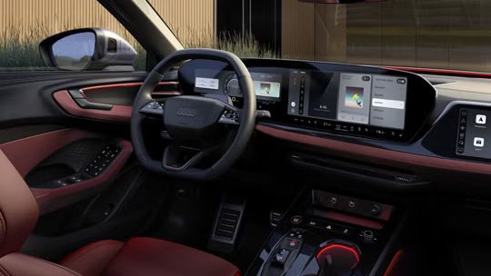 Interiér a kokpit modelu S5 Avant z pohľadu spolujazdca. Interiér je osvetlený červeným ambientným osvetlením. 