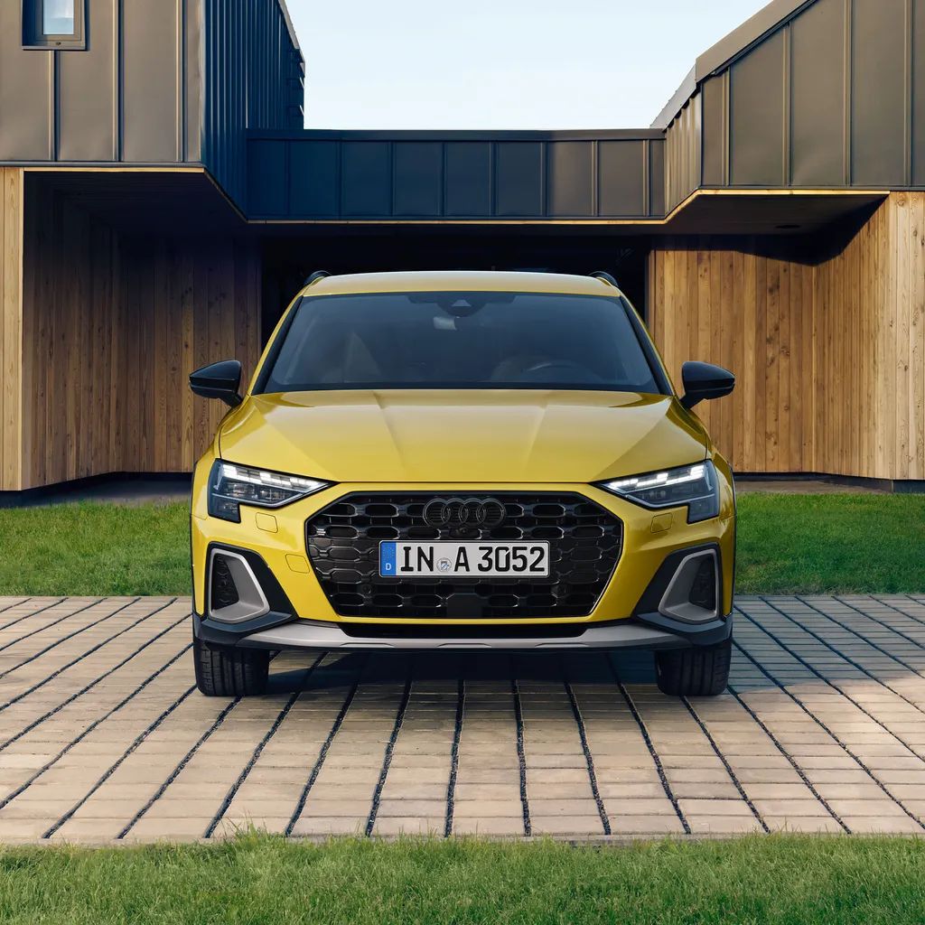 Žlté Audi A3 allstreet stojí pred modernou vilou.