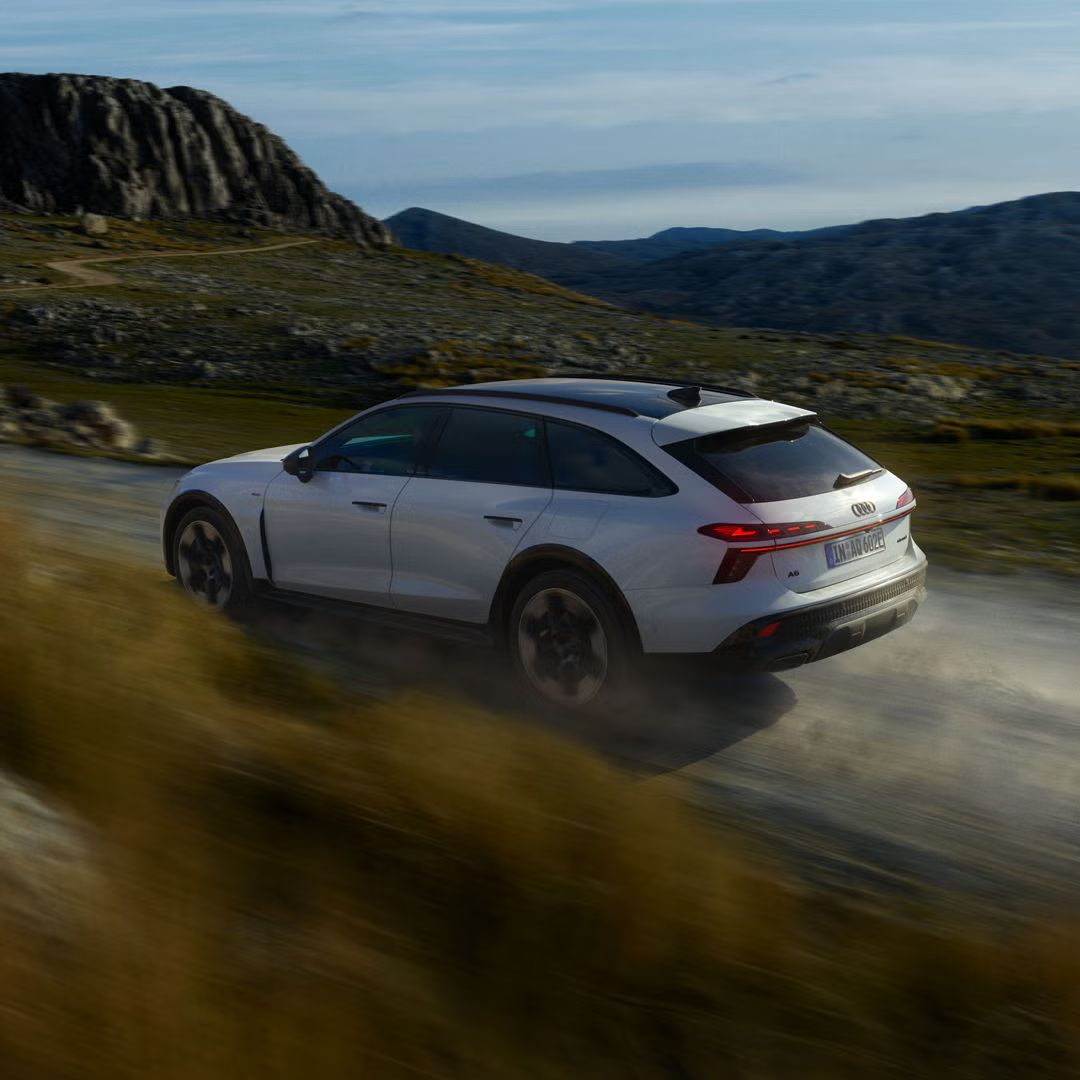 Audi A6 allroad e-hybrid z boku pri plnej rýchlosti na horskej ceste.