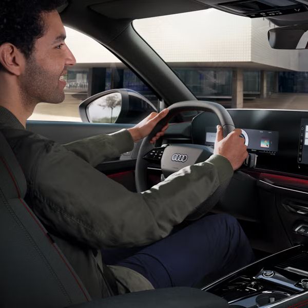 Pohľad zozadu na kokpit modelu Q3 Sportback, za volantom sedí mladý muž.