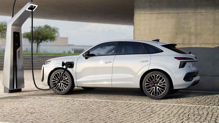 Bočný pohľad na Audi Q3 Sportback e-hybrid počas nabíjania.