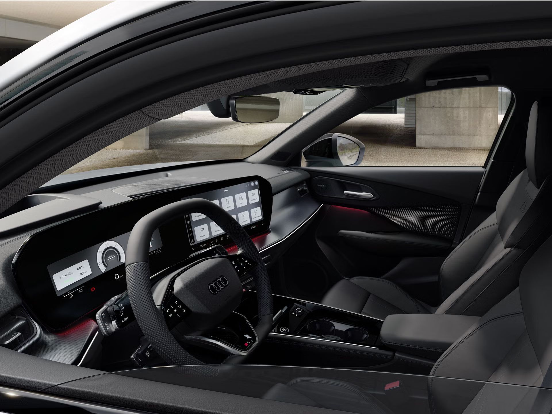 Pohľad zvonku cez spustené okno na volant, stredovú konzolu a digitálne displeje.