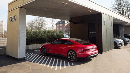 Červené Audi stojí pri nabíjacej stanici v Audi charging hub centre