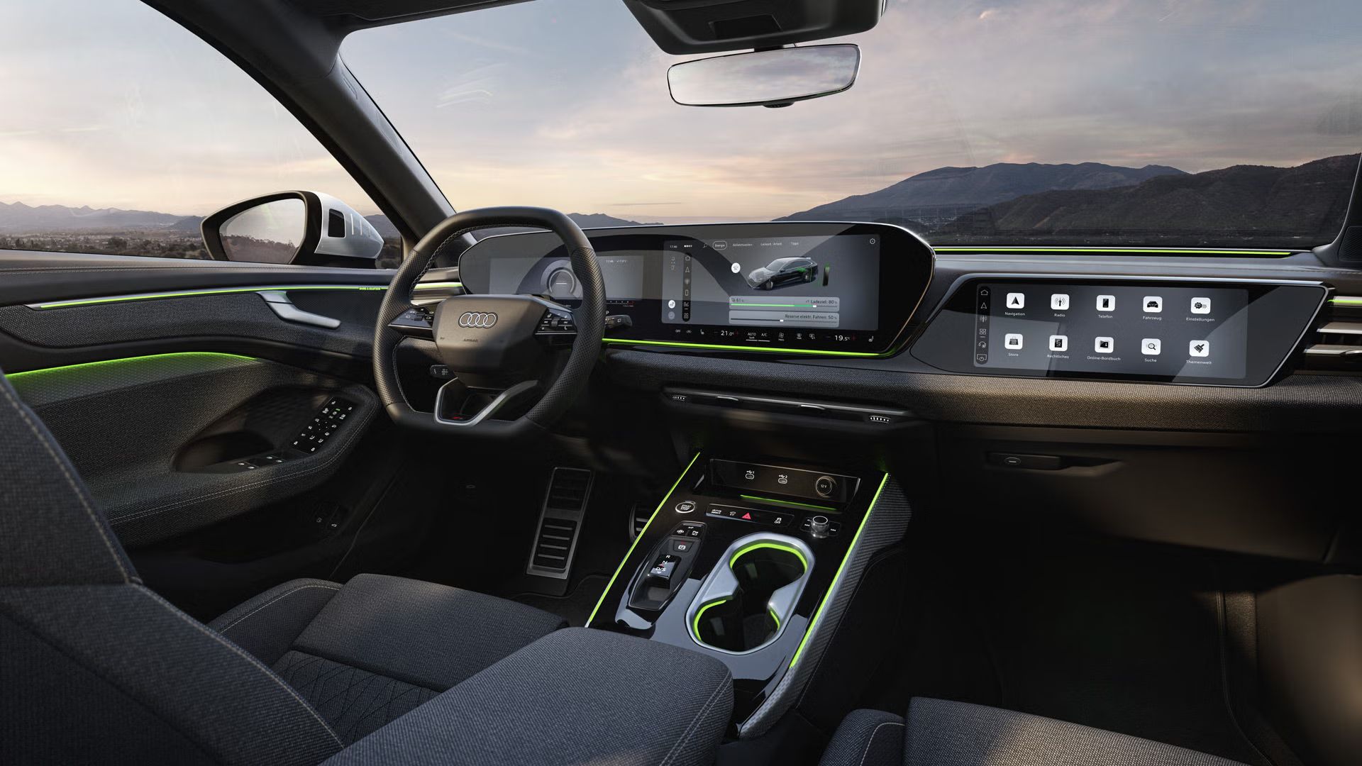 Pohľad na displeje a volant v kokpite modelu A6 Avant e-hybrid. Cez čelné sklo sú vidieť hory.